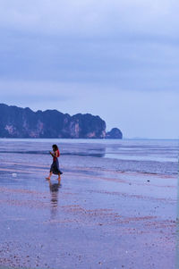 Full length of man on beach against sky