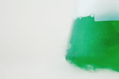 Close-up of colored pencils over white background