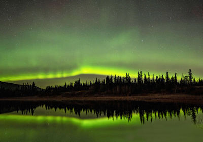 Scenic view of lake against sky at night