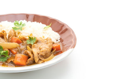 Close-up of food in plate on white background