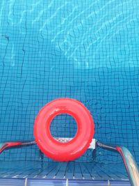 Directly above shot of red inflatable ring in swimming pool