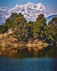 Scenic view of snowcapped mountains and lake against sky