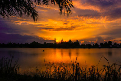 Scenic view of lake against sky during sunset