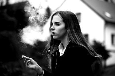 Close-up of young woman smoking cigarette