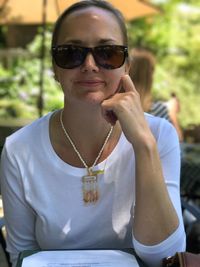 Close-up portrait of young woman wearing sunglasses