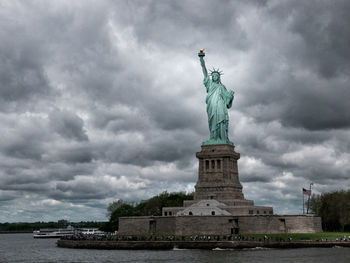 Low angle view of statue against cloudy sky