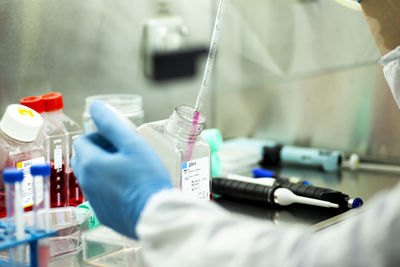 Midsection of scientist working in laboratory