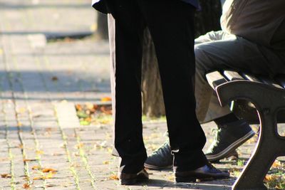 Low section of woman sitting outdoors