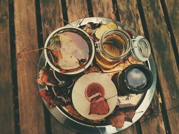 High angle view of drinks in plate on wooden table