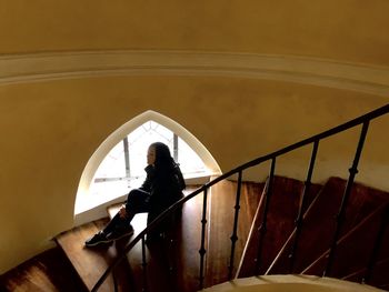 High angle view of woman standing on staircase