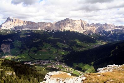 Scenic view of dolomites mountain range against cloudy sky