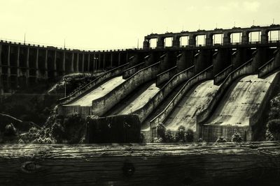 High angle view of dam amidst buildings against clear sky