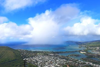 High angle view of townscape by sea against sky