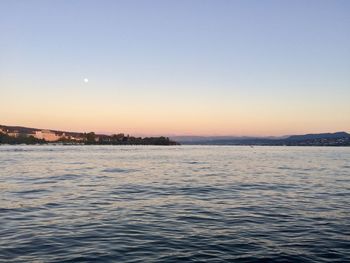 Scenic view of sea against clear sky at sunset