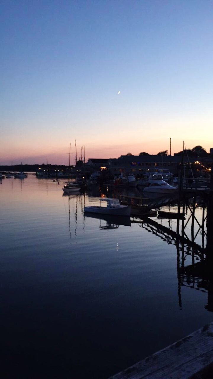 SAILBOATS MOORED AT HARBOR