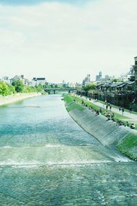 View of city at waterfront against sky