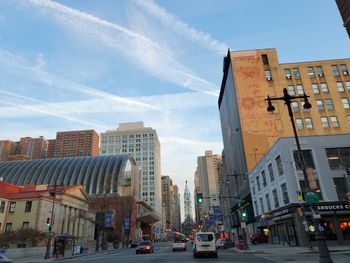 City street and buildings against sky