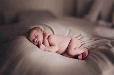 Young woman sleeping on bed at home