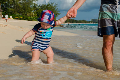 Full length of boys playing on beach