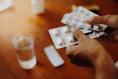 Midsection of man holding medicines