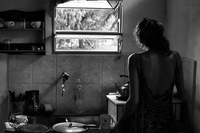 Rear view of woman looking at camera