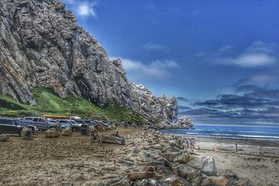 Scenic view of rocks on beach against sky