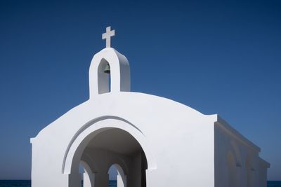 Low angle view of white building against blue sky