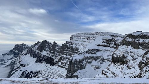 Scenic view of snowcapped mountains against sky