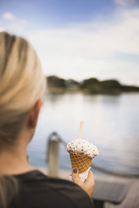 Woman's hand holding ice-cream cone