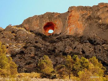 Low angle view of rock formation against sky