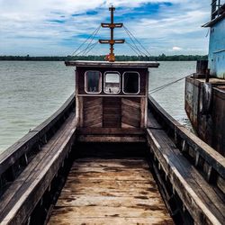 Ship moored on sea against sky