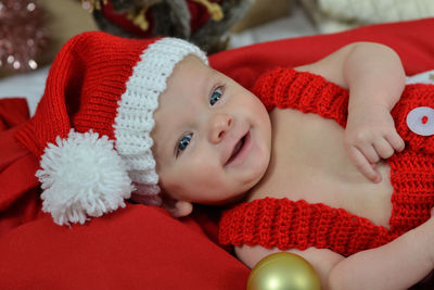 Portrait of a newborn baby in christmas clothes and santa hat