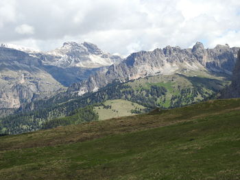 Scenic view of mountains against cloudy sky