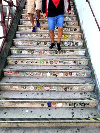 Low section of people walking on staircase