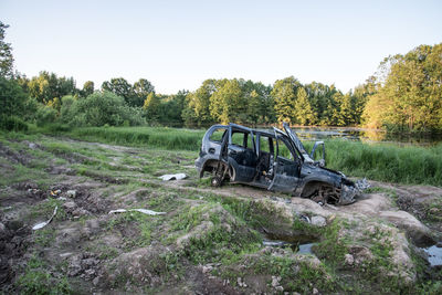 Abandoned truck on field against clear sky