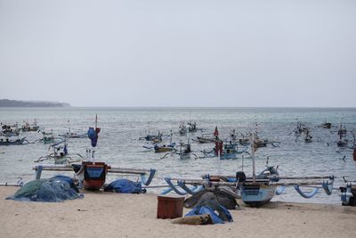 People on beach against clear sky