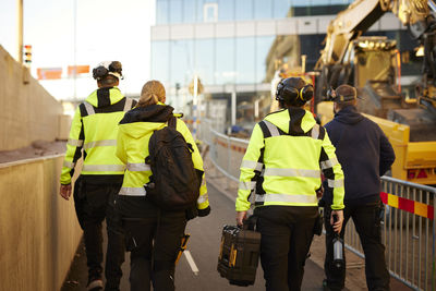 Rear view of workers at building site