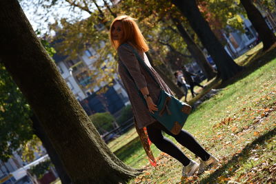 Side view of woman standing at park