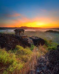 Scenic view of landscape against sky during sunset