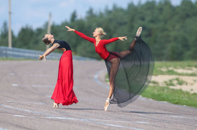 Rear view of woman playing with umbrella