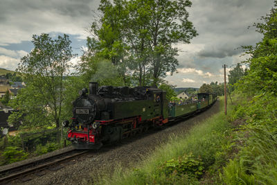 Train on railroad track against sky