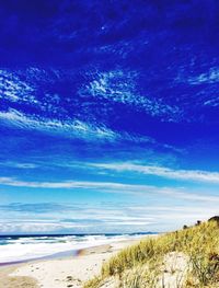 Scenic view of beach against blue sky
