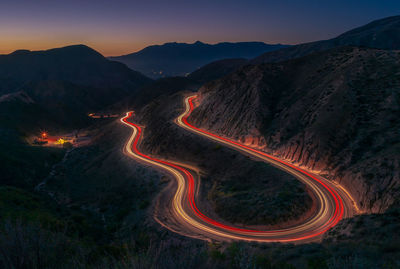 High angle view of light trails on road against sky at night