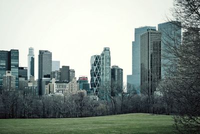 Buildings in city against clear sky