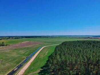 Scenic view of agricultural field against clear blue sky