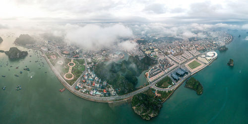 High angle view of cityscape against cloudy sky