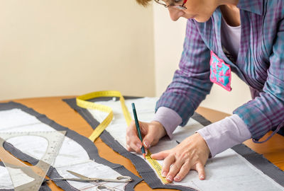 Midsection of woman working on table