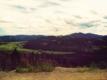 Scenic view of mountains against cloudy sky