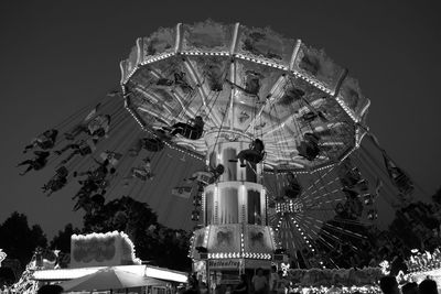 Low angle view of illuminated ferris wheel against sky