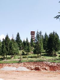 Trees on field against clear sky